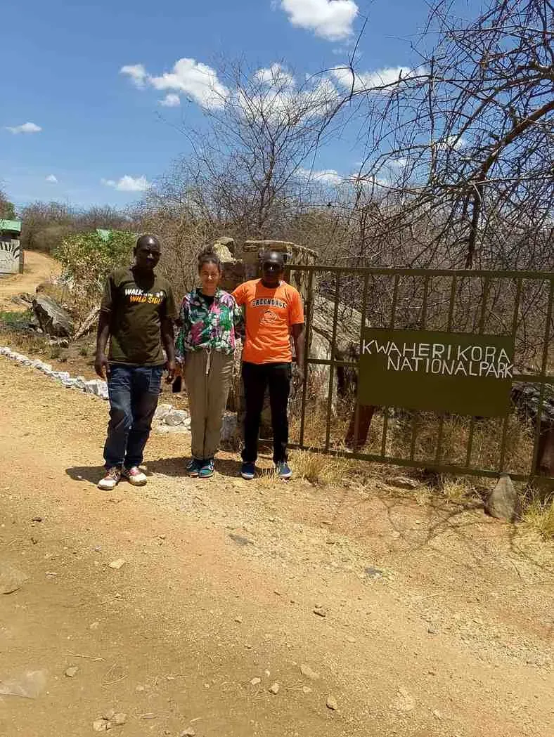 Three travellers at a national park entrance gate